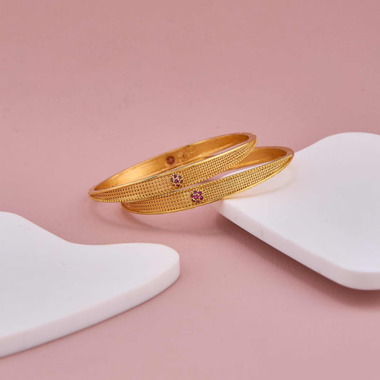 Regal Shine Gold Bangles with Minimal Ruby-Tone Embellishments