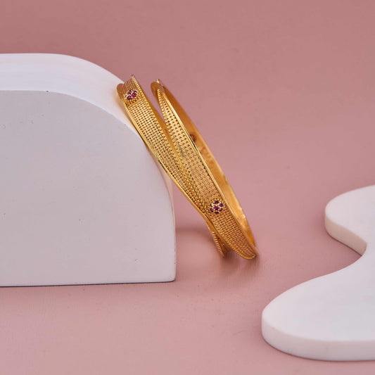 Regal Shine Gold Bangles with Minimal Ruby-Tone Embellishments
